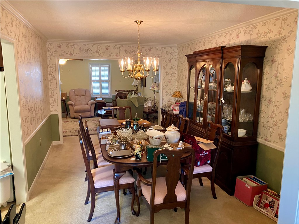 2026 Cardinal Park Drive Anderson, SC 29621 - Photo 14 of 41 This inviting dining area features elegant wallpaper and a classic chandelier, perfect for memorable gatherings.