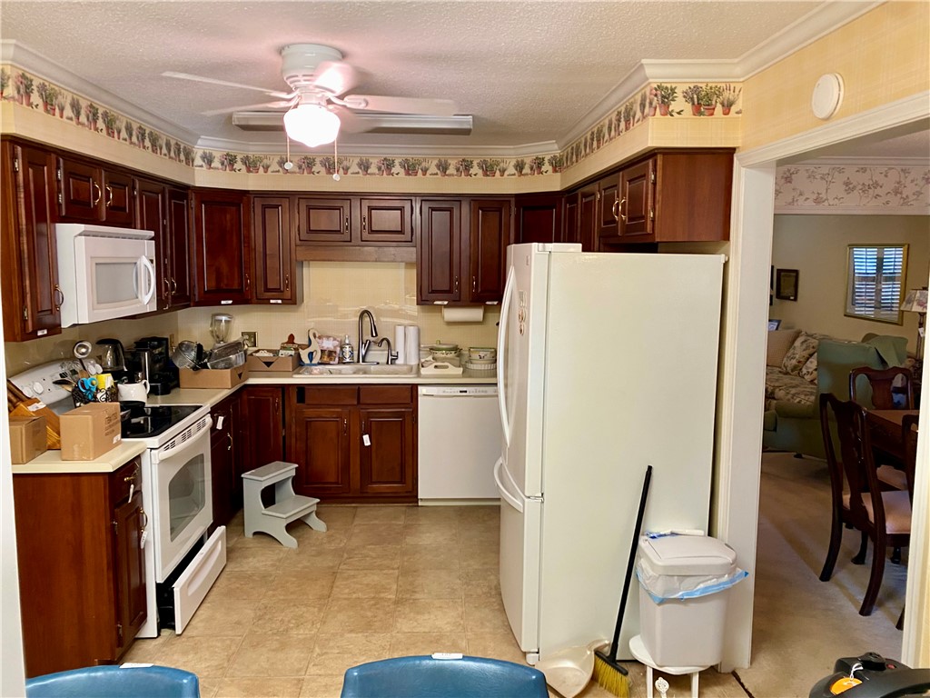 2026 Cardinal Park Drive Anderson, SC 29621 - Photo 18 of 41 This cozy kitchen features warm cabinetry and essential appliances for everyday living.