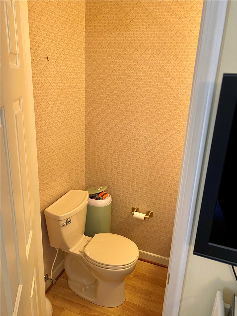 2026 Cardinal Park Drive Anderson, SC 29621 - Photo 24 of 41 This compact powder room features patterned walls and warm flooring, optimizing style and utility.