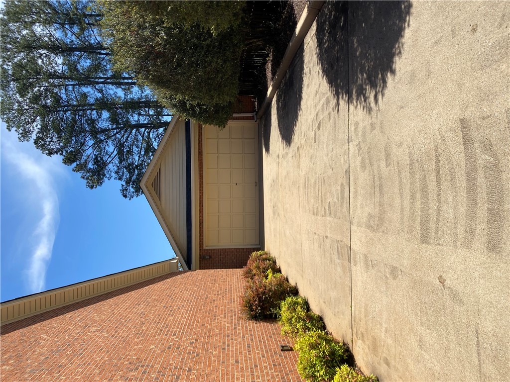 2026 Cardinal Park Drive Anderson, SC 29621 - Photo 4 of 41 This residence features a sturdy brick exterior and an attached garage with a paved driveway.