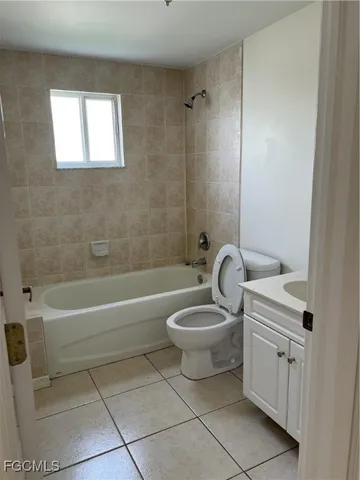 a bathroom with a toilet a sink and bathtub
