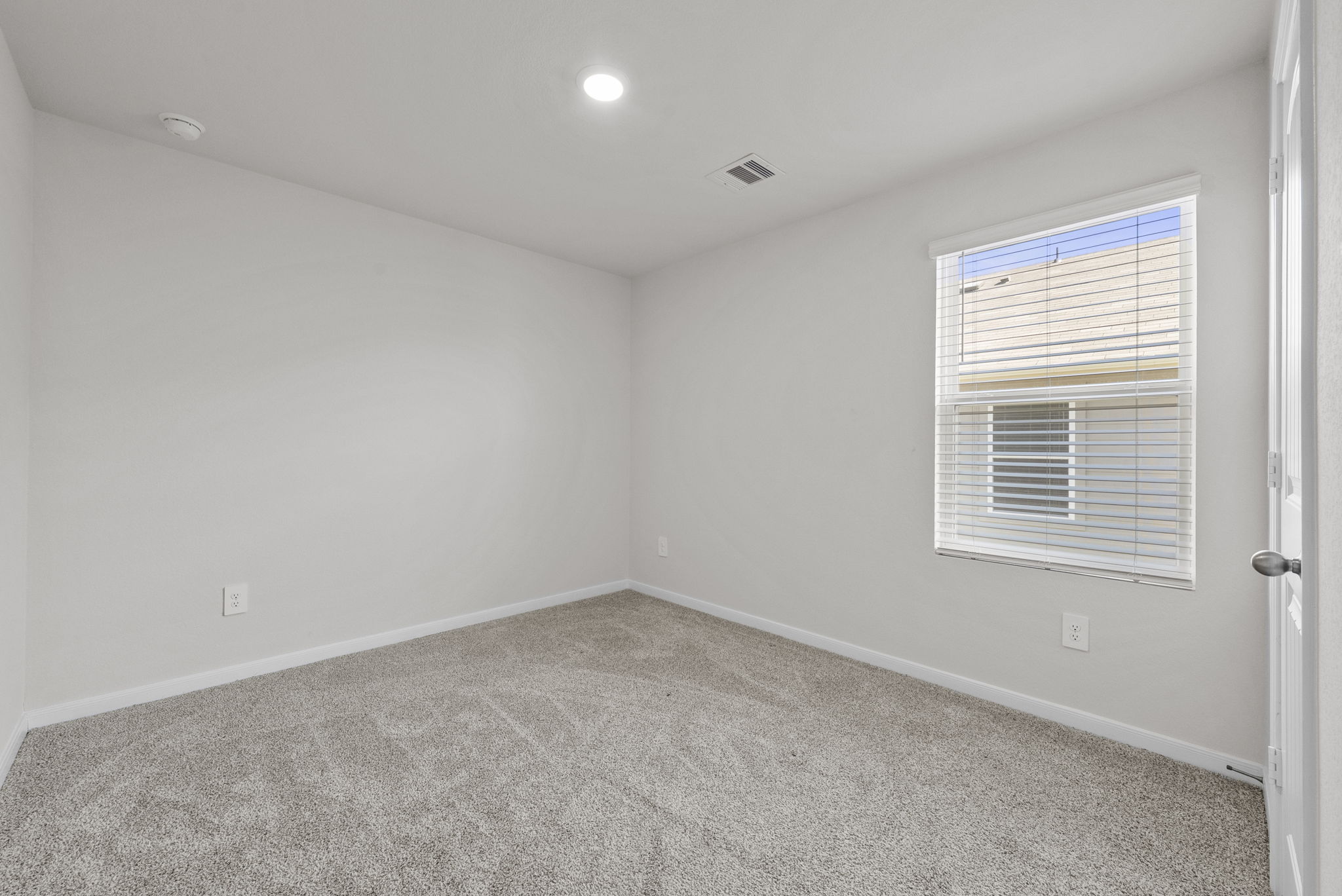 320 Darwin Place Lockhart, TX 78644 - Photo 12 of 31 Empty room featuring light colored carpet and recessed lighting