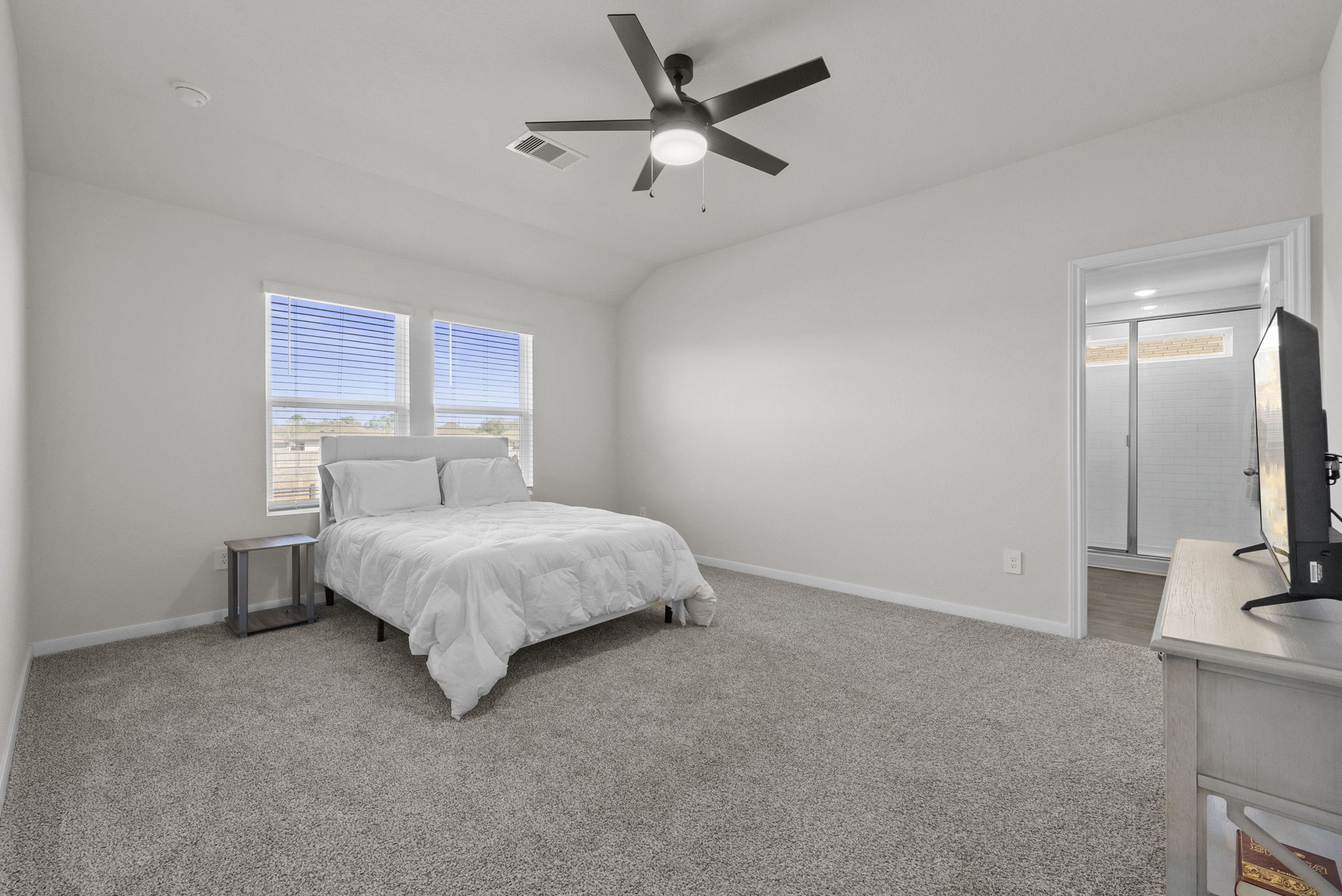 320 Darwin Place Lockhart, TX 78644 - Photo 21 of 31 Bedroom featuring light carpet, a ceiling fan, and lofted ceiling