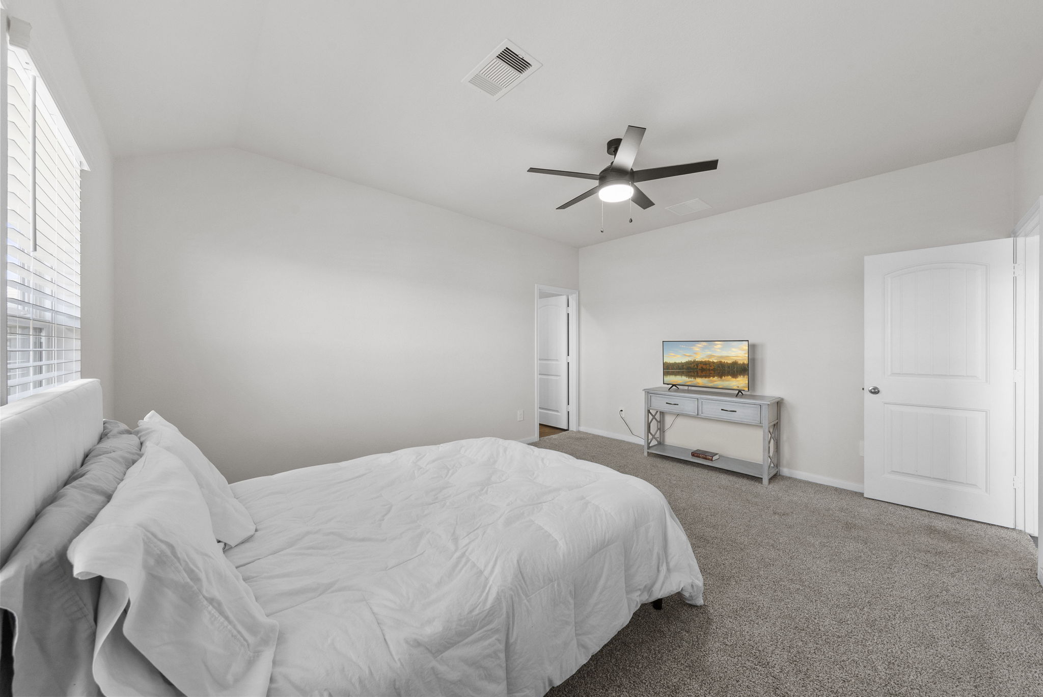 320 Darwin Place Lockhart, TX 78644 - Photo 22 of 31 Bedroom featuring carpet flooring, ceiling fan, and vaulted ceiling