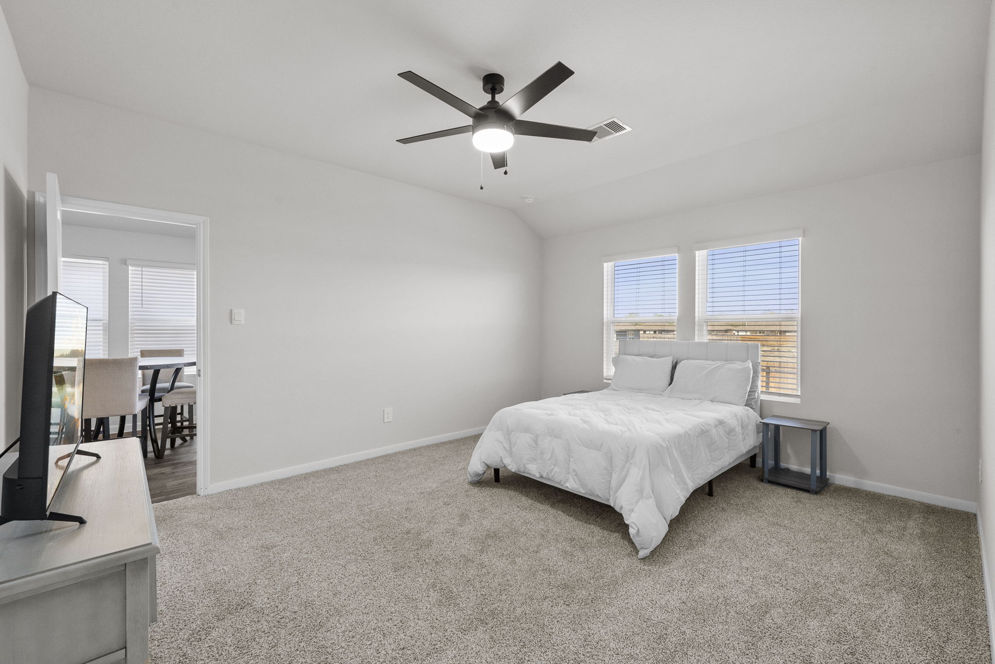 320 Darwin Place Lockhart, TX 78644 - Photo 23 of 31 Bedroom featuring light carpet, ceiling fan, and vaulted ceiling