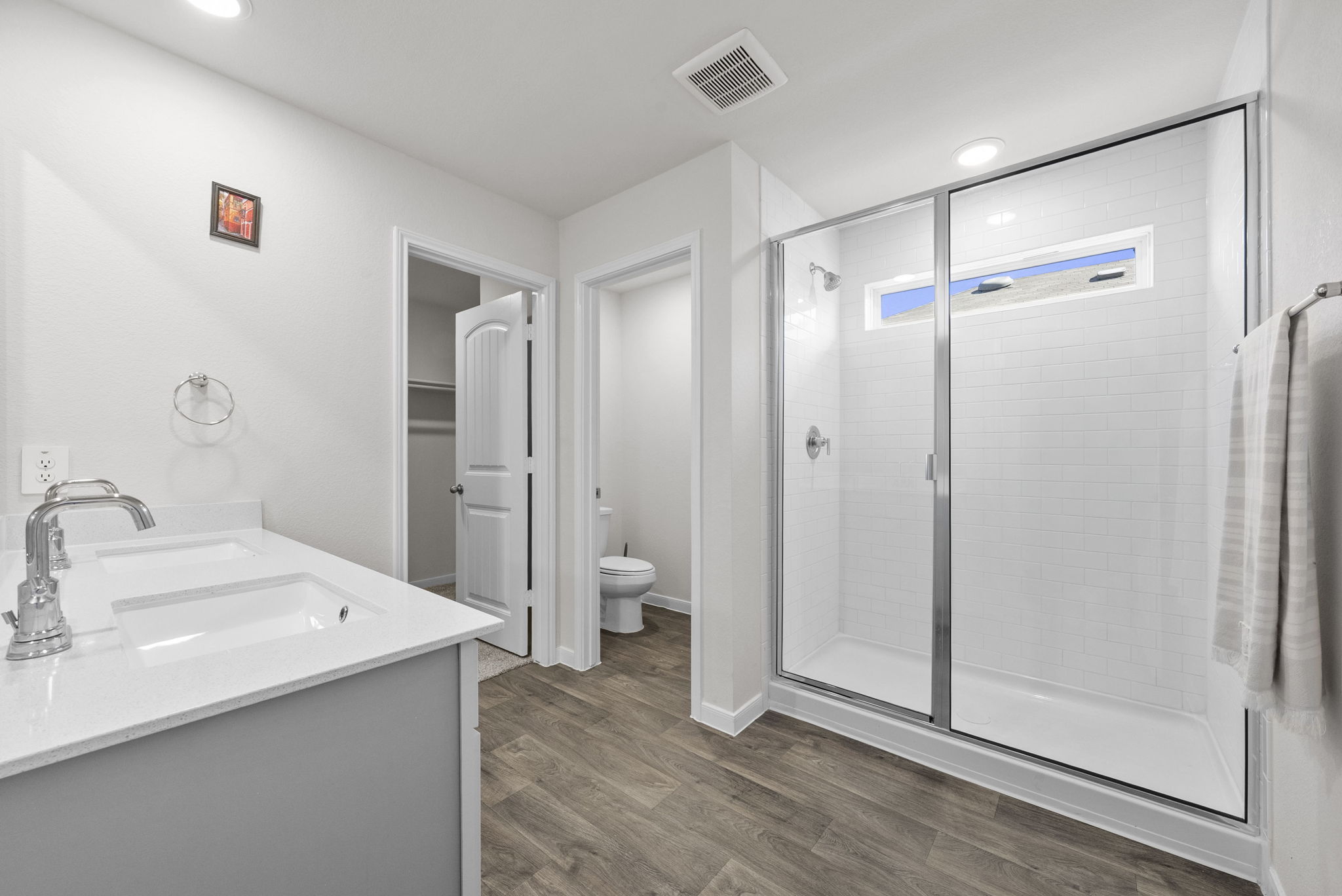 320 Darwin Place Lockhart, TX 78644 - Photo 24 of 31 Full bathroom featuring double vanity, dark wood finished floors, a stall shower, a spacious closet, and recessed lighting