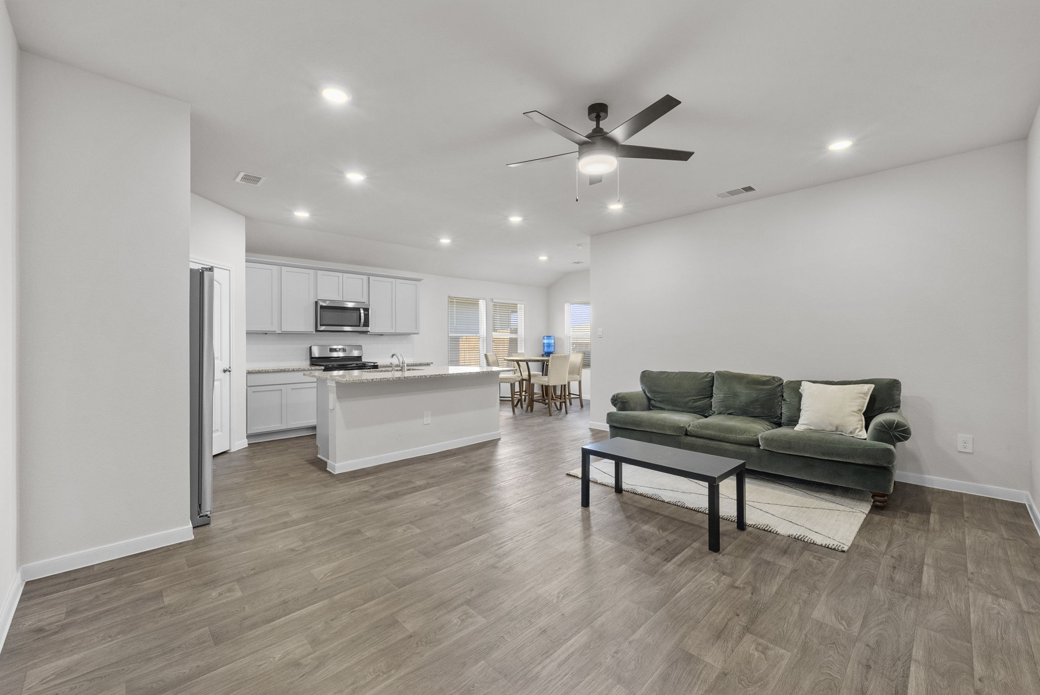 320 Darwin Place Lockhart, TX 78644 - Photo 3 of 31 Living room featuring ceiling fan, light wood finished floors, recessed lighting, and lofted ceiling
