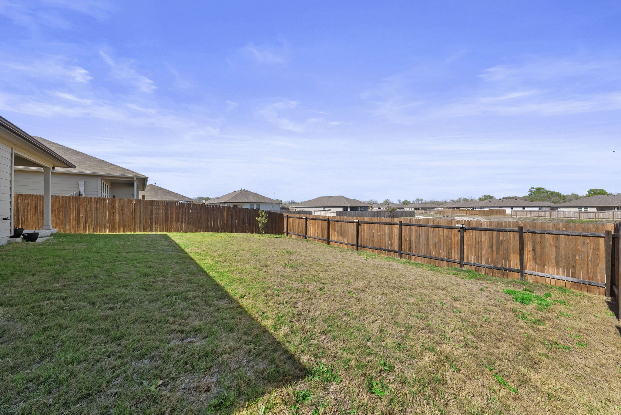 320 Darwin Place Lockhart, TX 78644 - Photo 8 of 31 Fenced backyard with a residential view