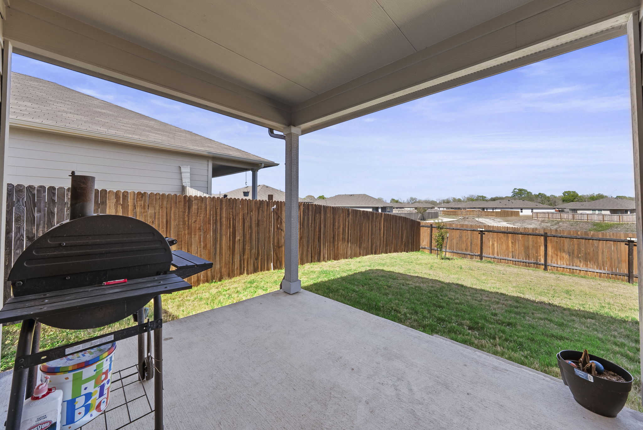 320 Darwin Place Lockhart, TX 78644 - Photo 9 of 31 Fenced backyard with a grill and a patio area