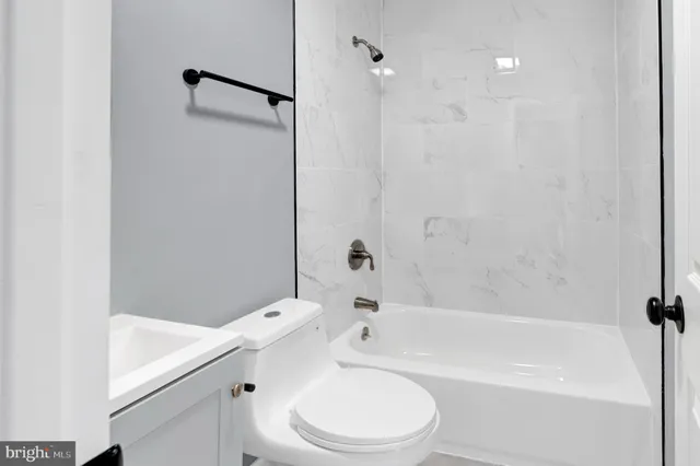 a bathroom with a bathtub toilet and sink