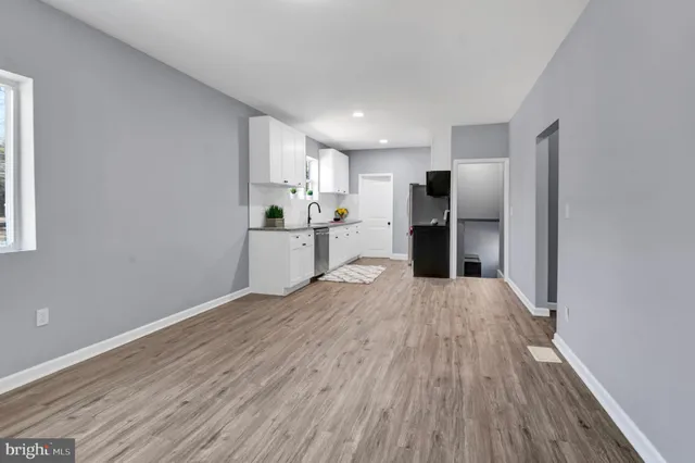 a room with a wooden floor and window