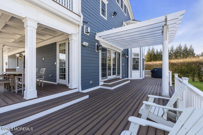 Undisclosed Address Spring Lake, NJ 07762 - Photo 47 of 67 a view of a patio with table and chairs with wooden floor and fence