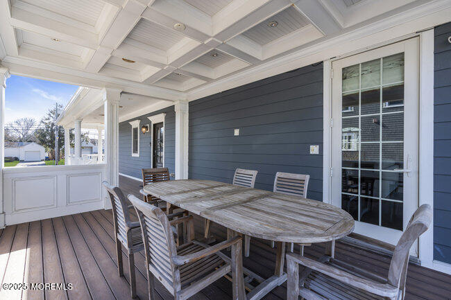 Undisclosed Address Spring Lake, NJ 07762 - Photo 53 of 67 a view of a deck with table and chairs with wooden floor and fence