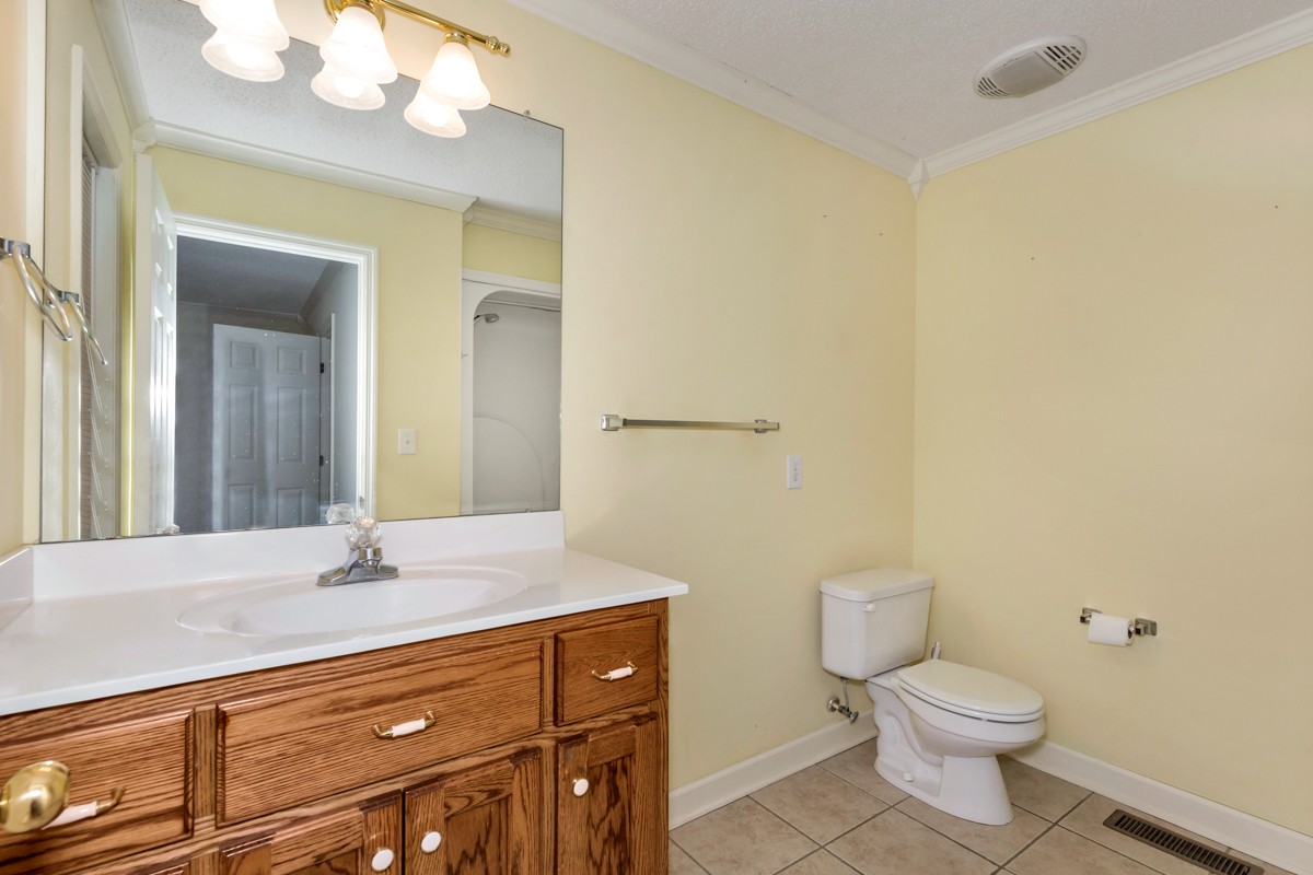 168 Lake Logan Road Ardmore, TN 38449 - Photo 13 of 27 a bathroom with a sink a toilet and a mirror