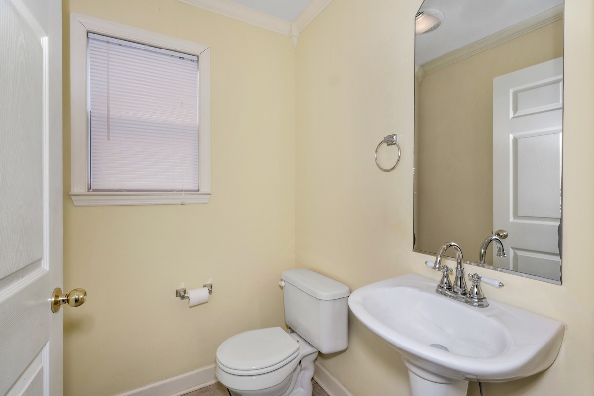 168 Lake Logan Road Ardmore, TN 38449 - Photo 15 of 27 a bathroom with a sink a toilet and mirror