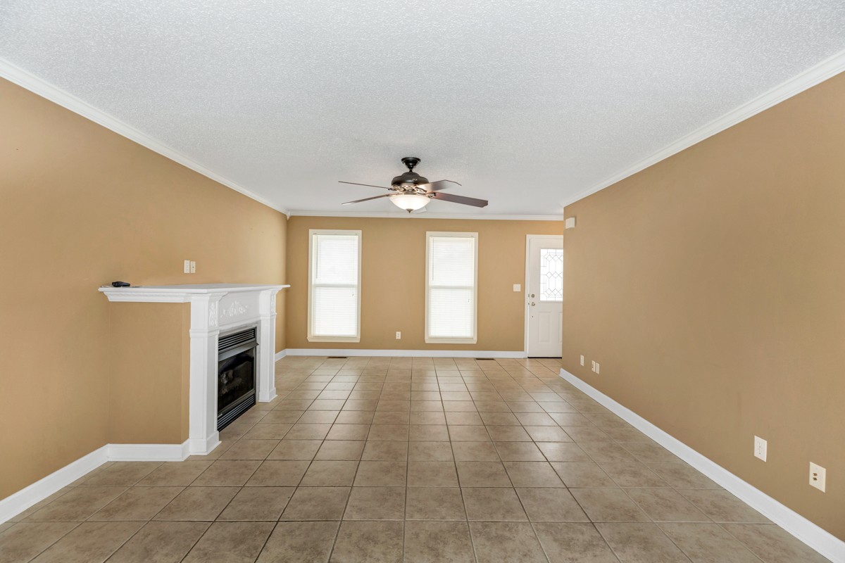 168 Lake Logan Road Ardmore, TN 38449 - Photo 6 of 27 a view of an empty room with a fireplace and a window