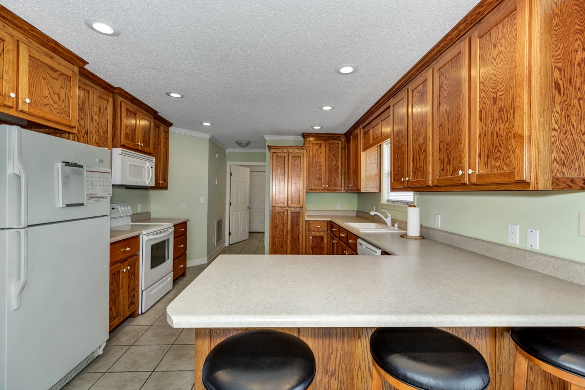 168 Lake Logan Road Ardmore, TN 38449 - Photo 7 of 27 a kitchen with stainless steel appliances a sink a stove a refrigerator cabinets and a counter top space