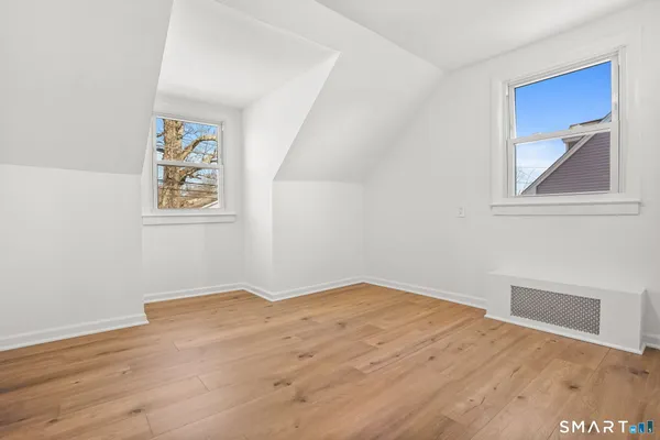 a view of an empty room with wooden floor