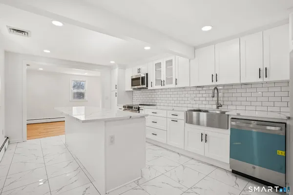 a view of a kitchen with a sink and an oven