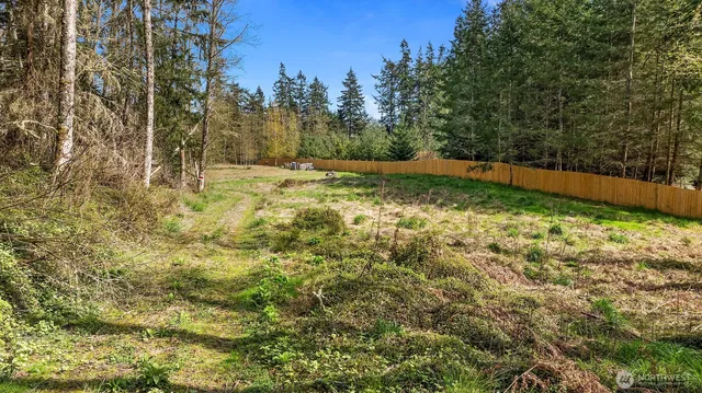 a backyard of a house with yard fountain and outdoor seating