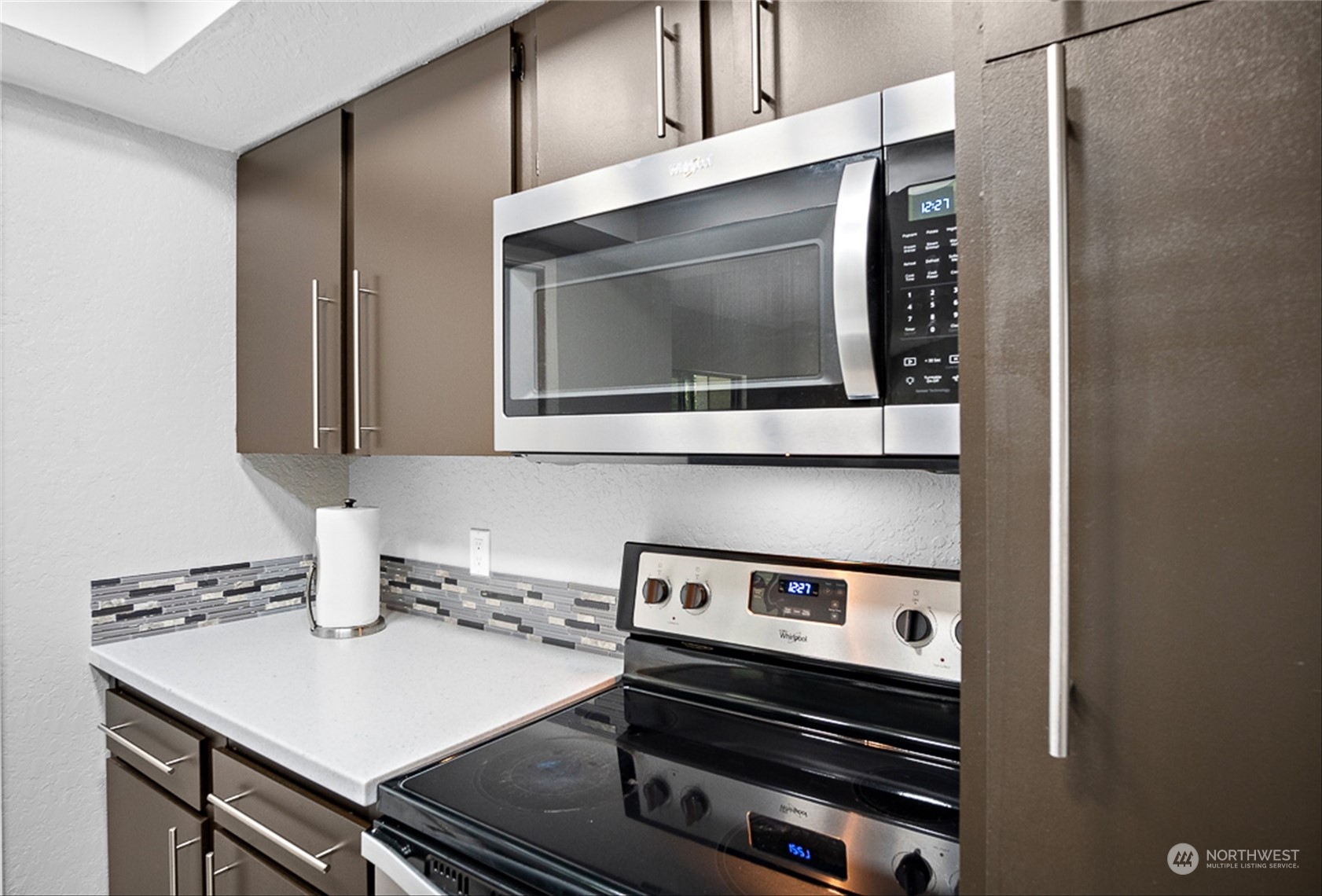 14401 Southeast Petrovitsky Road, Unit E202 Renton, WA 98058 - Photo 15 of 26 a kitchen with a stove and a microwave