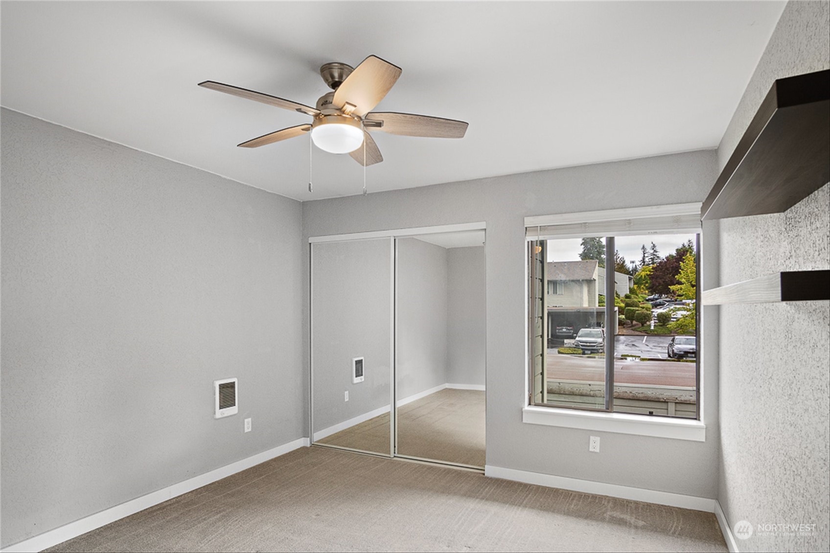 14401 Southeast Petrovitsky Road, Unit E202 Renton, WA 98058 - Photo 22 of 26 a view of a livingroom with a ceiling fan and window