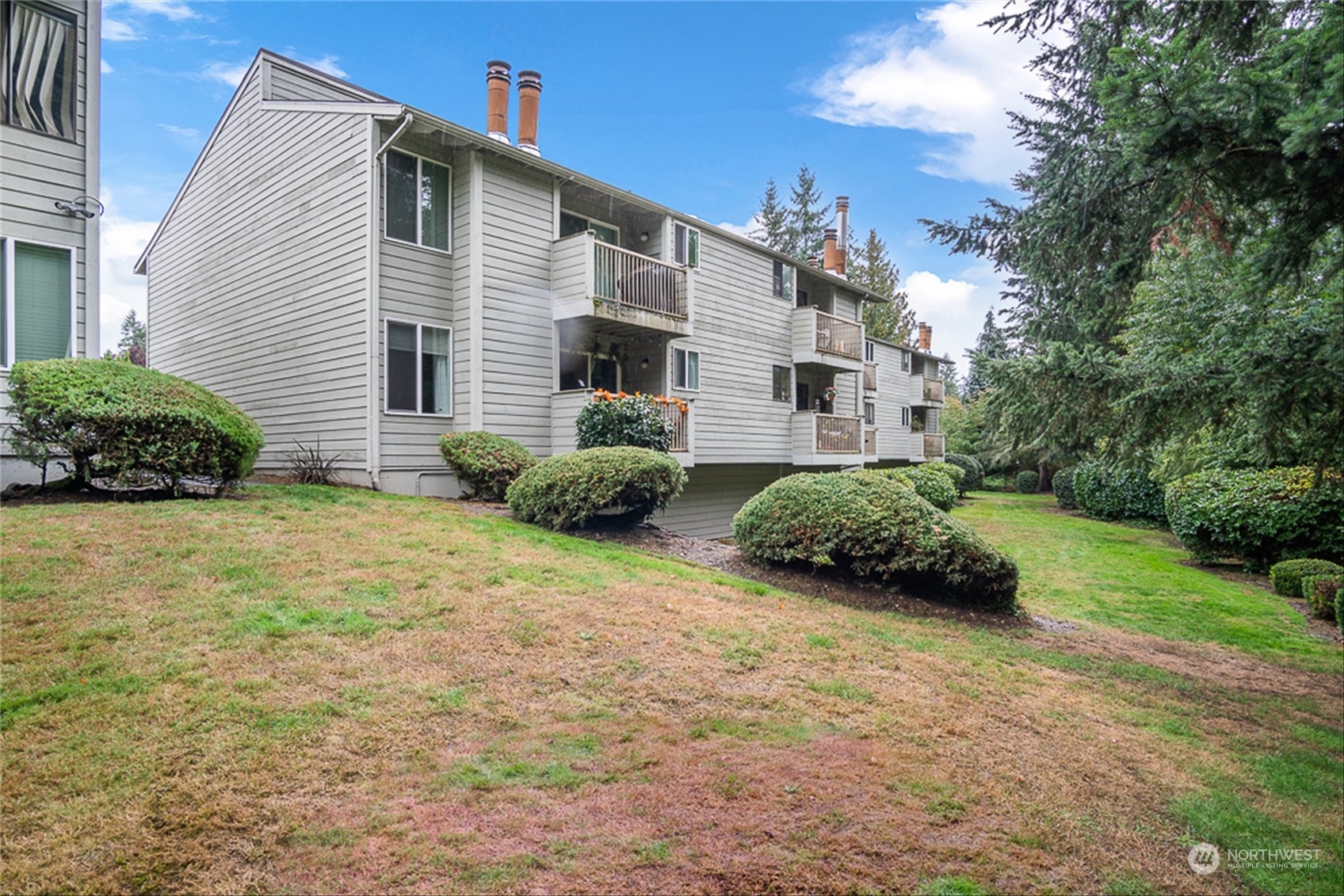 14401 Southeast Petrovitsky Road, Unit E202 Renton, WA 98058 - Photo 24 of 26 a front view of a house with a garden