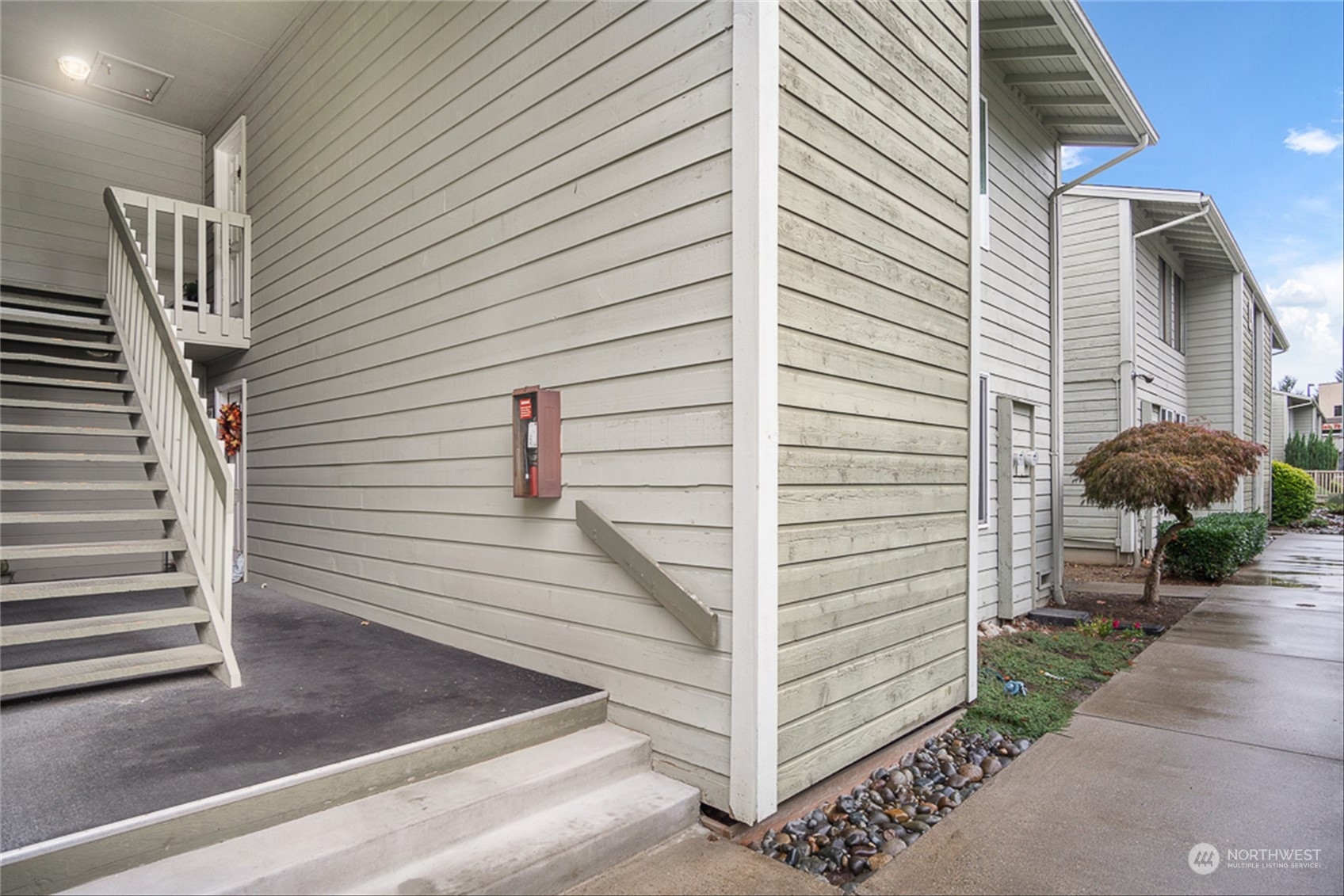 14401 Southeast Petrovitsky Road, Unit E202 Renton, WA 98058 - Photo 5 of 26 a view of a house with a door and wooden floor