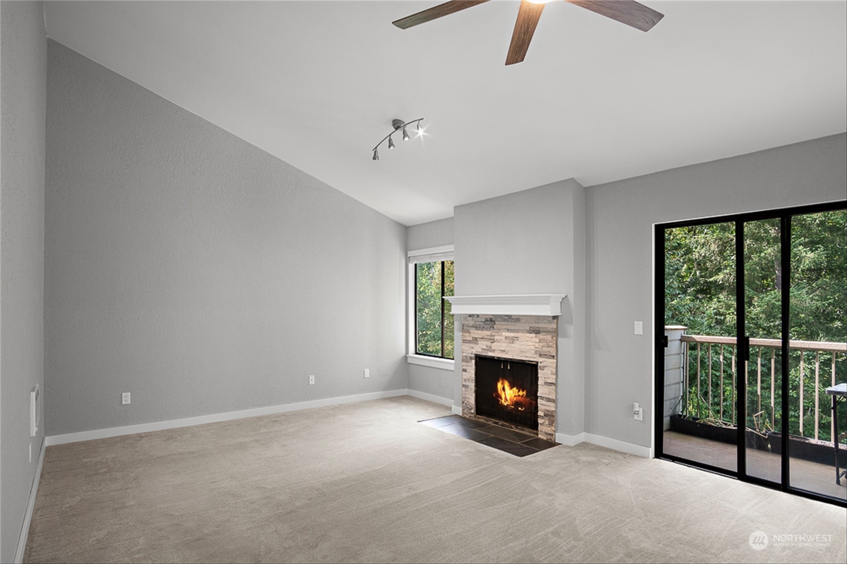14401 Southeast Petrovitsky Road, Unit E202 Renton, WA 98058 - Photo 10 of 26 a view of an empty room with fireplace and a window