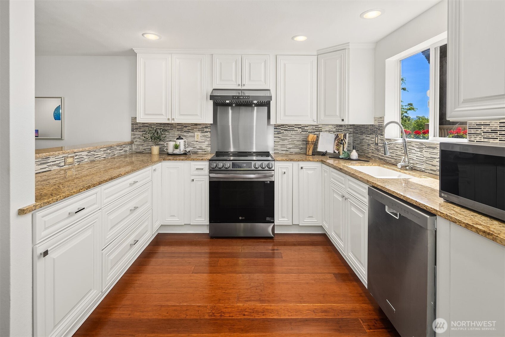 379 100th Avenue Northeast, Unit A Bellevue, WA 98004 - Photo 11 of 38 a kitchen with a sink stove and cabinets
