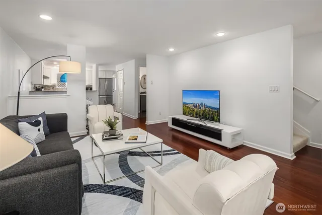 a living room with furniture and wooden floor
