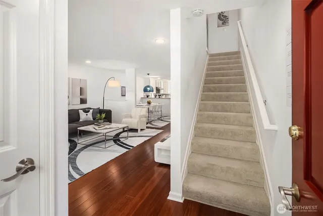 a view of entryway and hall with wooden floor