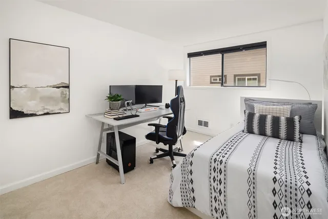 a bedroom with a bed and a desk