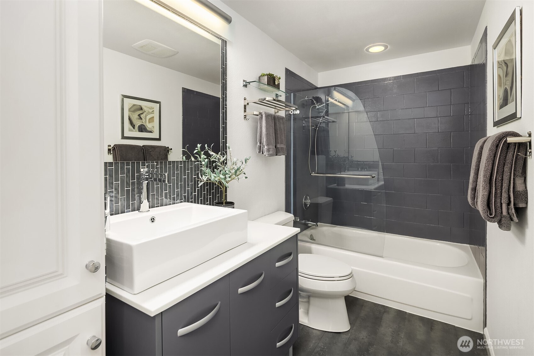 379 100th Avenue Northeast, Unit A Bellevue, WA 98004 - Photo 22 of 38 a bathroom with a sink a toilet and shower