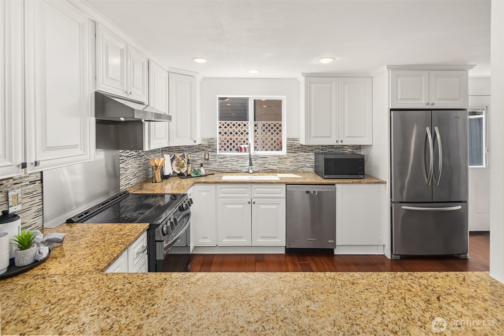 379 100th Avenue Northeast, Unit A Bellevue, WA 98004 - Photo 10 of 38 a kitchen with a refrigerator sink and cabinets