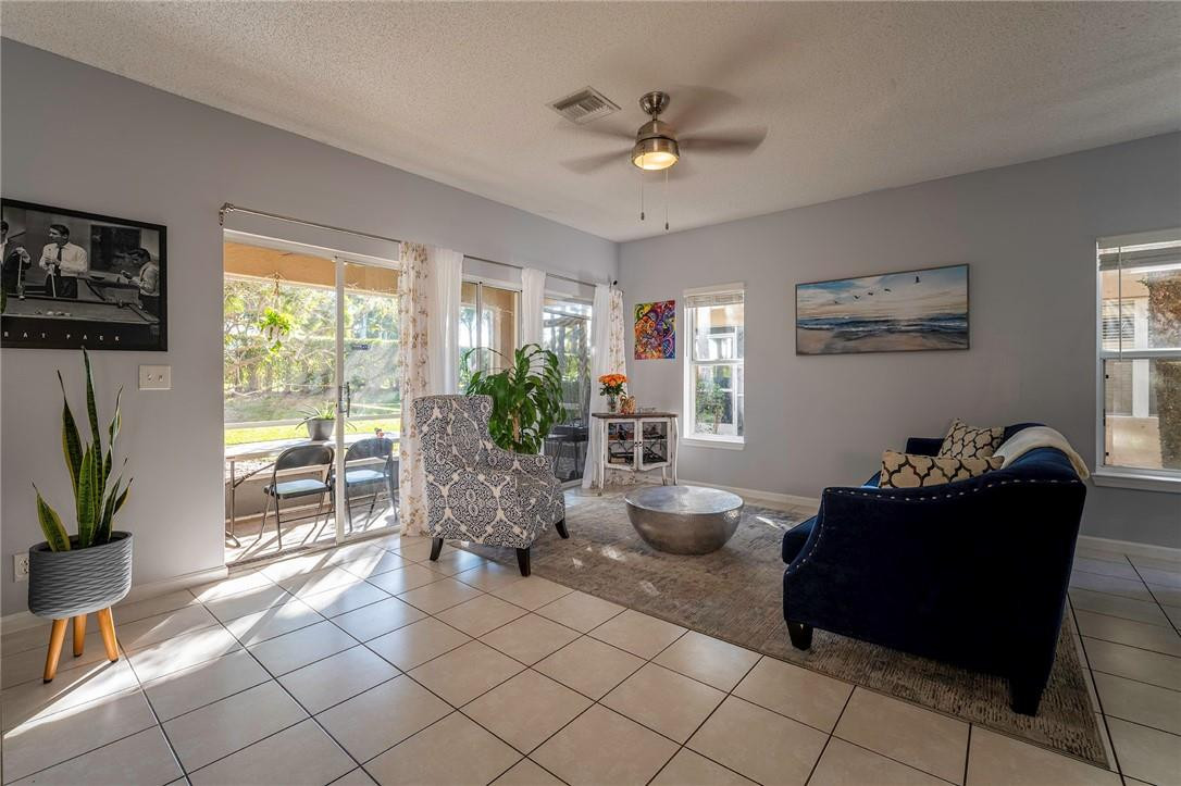 6960 Brook Hollow Road Lake Worth, FL 33467 - Photo 1 of 24 a living room with furniture and a floor to ceiling window