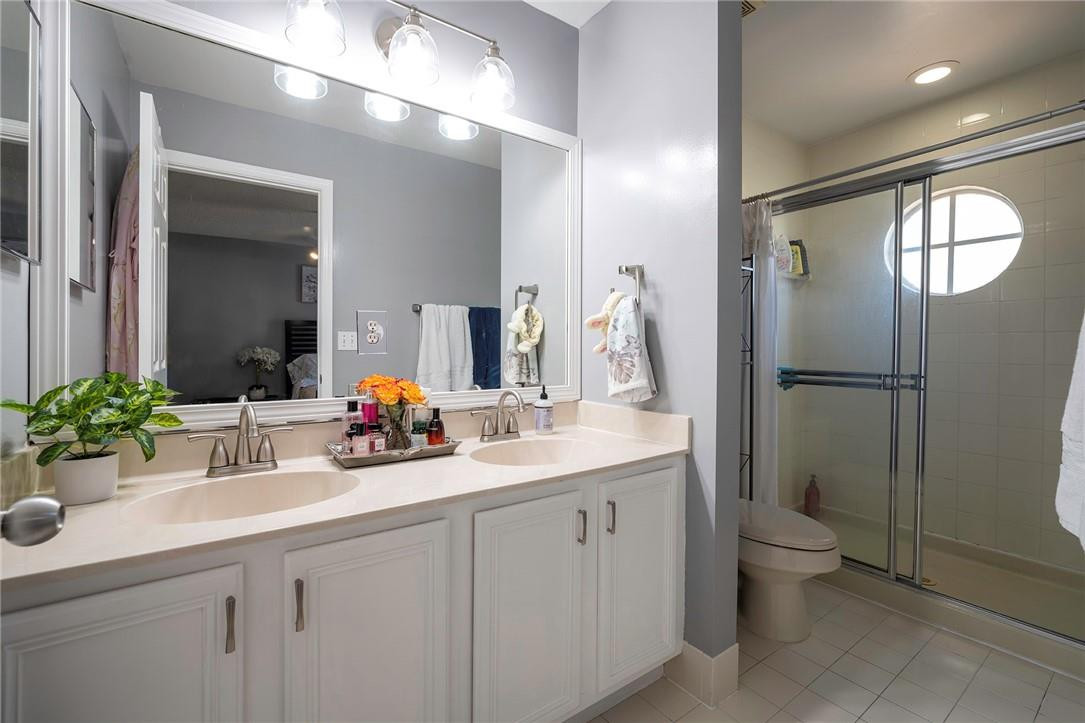 6960 Brook Hollow Road Lake Worth, FL 33467 - Photo 11 of 24 a bathroom with a sink toilet and shower