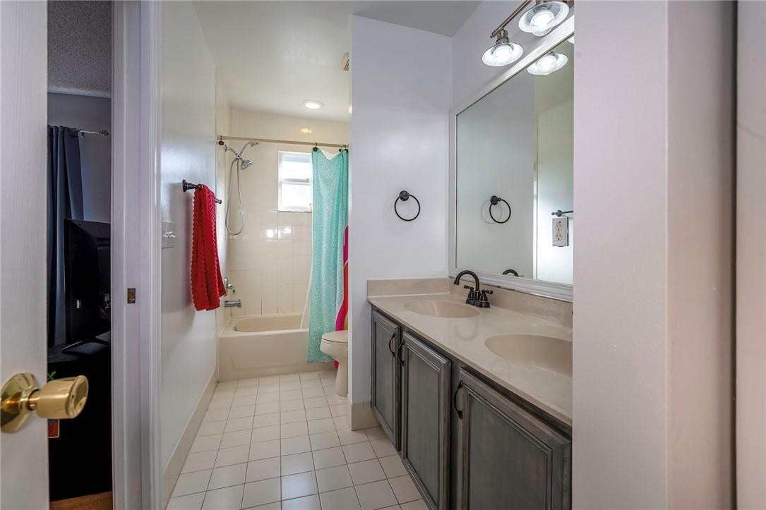 6960 Brook Hollow Road Lake Worth, FL 33467 - Photo 13 of 24 a spacious bathroom with a granite countertop sink a toilet a mirror and shower