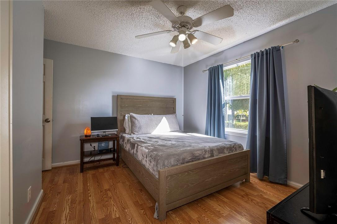 6960 Brook Hollow Road Lake Worth, FL 33467 - Photo 14 of 24 a bedroom with a bed and a chandelier