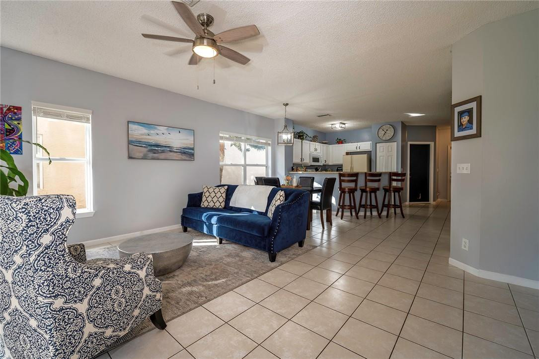 6960 Brook Hollow Road Lake Worth, FL 33467 - Photo 2 of 24 a living room with furniture and a dining table with kitchen view