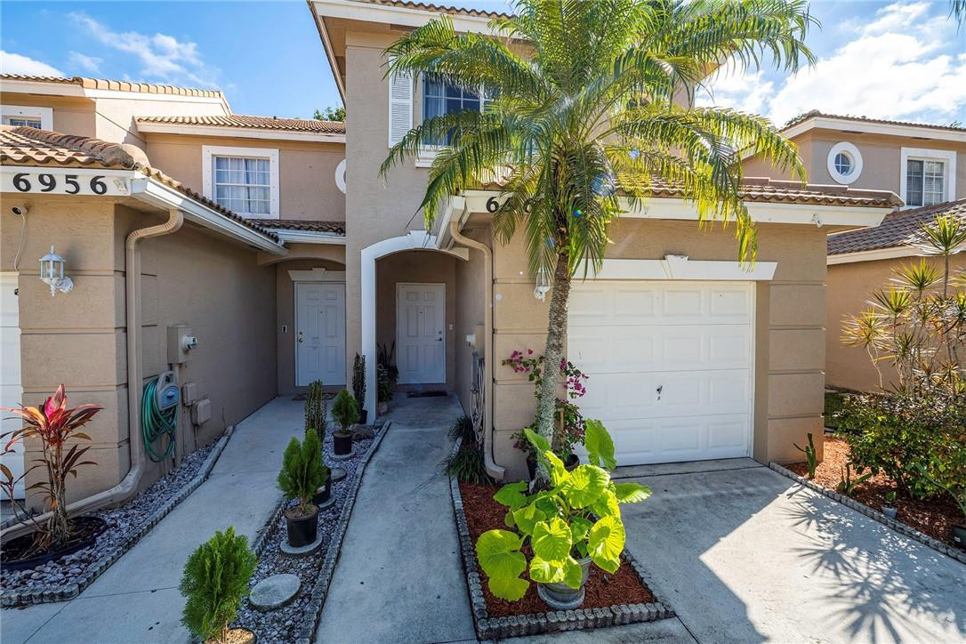 6960 Brook Hollow Road Lake Worth, FL 33467 - Photo 22 of 24 a front view of a house