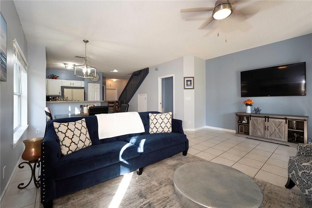 6960 Brook Hollow Road Lake Worth, FL 33467 - Photo 3 of 24 a living room with furniture and a flat screen tv
