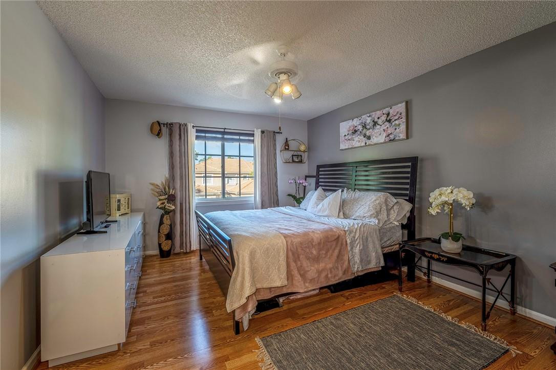 6960 Brook Hollow Road Lake Worth, FL 33467 - Photo 9 of 24 a bedroom with a bed and wooden floor