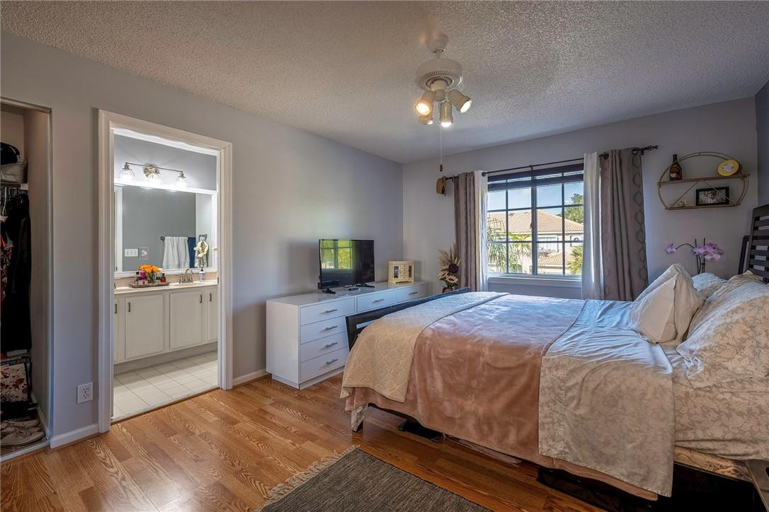 6960 Brook Hollow Road Lake Worth, FL 33467 - Photo 10 of 24 a bedroom with a large bed and a tv