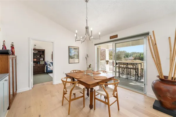 a view of a dining room with furniture and a kitchen