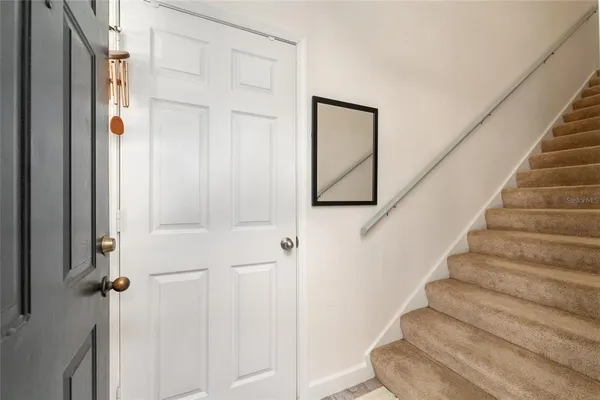 a view of a hallway with workspace and a living room