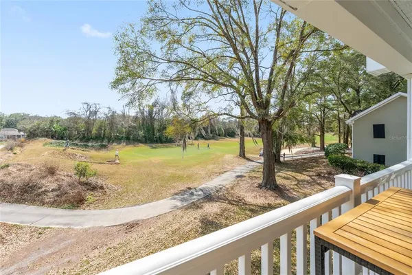 an aerial view of a house with yard and tree s