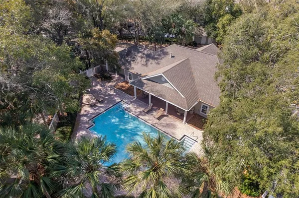 an aerial view of a house with a yard