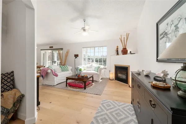 a living room with furniture a fireplace and a flat screen tv