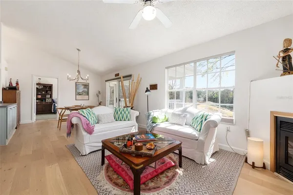 a living room with furniture fireplace and a large window